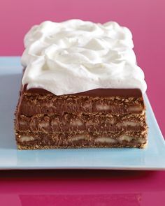 a piece of chocolate cake with whipped cream on top is sitting on a blue plate