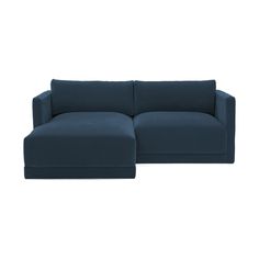 a blue sectional couch sitting on top of a white floor