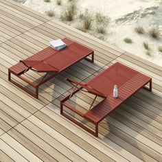 two red tables sitting on top of a wooden deck next to a bottle of water