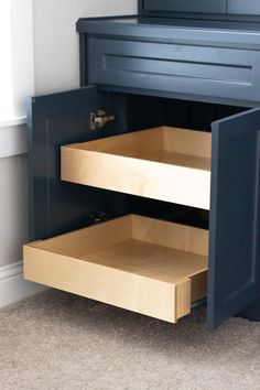 an open cabinet with drawers in the corner