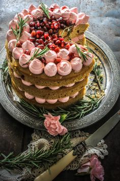 a cake with cranberries and rosemary on top