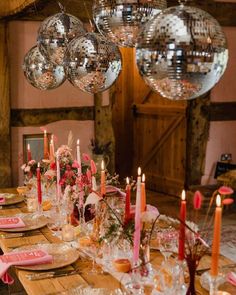 a long table with plates and candles on it