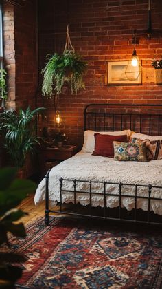 a bed sitting in a bedroom next to a window with potted plants on it