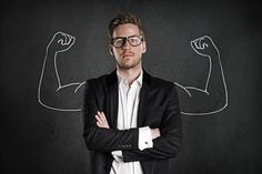 a man with his arms crossed standing in front of a chalkboard that says women like confident men