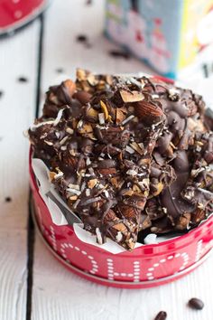 a red container filled with chocolate and nuts