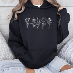 Available In Unisex Xs, S, M, L, Xl, And Xxl. Just Place An Order And Message Your Size After! Wildflowers Hoodie Embrace The Beauty Of Nature With Our ""Wildflowers Hoodie""! This Stylish Hoodie Features A Charming Vintage Wildflower Design, Perfect For Botanical Lovers And Those Who Appreciate Floral Aesthetics. Made From Soft, Comfortable Fabric, It's An Ideal Gift For Moms, Especially On Mother's Day, Or Anyone Who Loves A Trendy Yet Cozy Look. The Spacious Kangaroo Pocket And Adjustable Dra Casual Black Floral Print Sweatshirt, White Casual Hoodie With Floral Print, White Cotton Hoodie With Floral Print, Black Floral Print Sweatshirt For Spring, White Floral Print Cotton Hoodie, Winter Floral Print Hoodie Sweatshirt, White Floral Print Hoodie For Spring, Winter Floral Print Sweatshirt, Winter Floral Print Cotton Hoodie