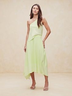 This floaty skirt is cut from a squared shape to increase the sweep of its skirt and create a handkerchief hemline.  For fabric, we selected our signature silk charmeuse, a fabric we love for its beautiful drape, satin-like shine, and ease of care.  High-rise with A-line skirt.  Invisible zip at wearer's left.  Handkerchief hem.  Fully lined.  High-rise with A-line skirt.  Maxi length.  Model: Size 2, 5'10" (178cm). Handkerchief Hem Skirt, Silk Handkerchief, Skirt Maxi, Handkerchief Hem, Hem Skirt, Beautiful Drapes, Silk Charmeuse, Invisible Zip, A Line Skirt