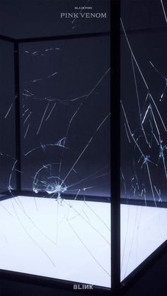 a broken glass display case in a dark room