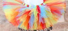 A stunning, fluffy, colorful tutu has red, blue, yellow, orange, and green tulle. All tutus are made with high quality tulle and a 1" non-roll waist band.  I make all my tutus very full and fluffy.  I put as much tulle as I can possibly fit. Each tutu has a matching bow attached. When measuring your child's waist, order the size that is 2 inches smaller than her actual waist since the band is made of elastic. Tutu Size Chart 0-6 mo         14" waist    6"length 6-12 mo       15"waist     6"lengt Playful Rainbow Tulle Tutu Dress, Fun Multicolor Summer Tutu Dress, Fitted Multicolor Tutu Dress With Tulle Skirt, Fitted Multicolor Tutu Dress For Fun, Fun Fitted Multicolor Tutu Dress, Playful Multicolor Tulle Tutu Dress, Multicolor Playful Tulle Tutu Dress, Multicolor Tulle Tutu Dress For Costume Party, Cute Multicolor Tulle Tutu Dress