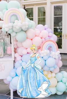 there is a large balloon arch with princess on it