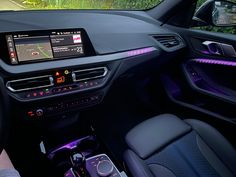 the interior of a modern car with touchscreens and steering wheel drive assist system