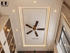 an overhead view of a ceiling fan in a living room with built - in bookshelves