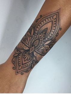 a person with a tattoo on their arm that has an intricate design in the middle