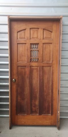 an old wooden door in front of a garage