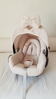 an infant car seat with a bow on it