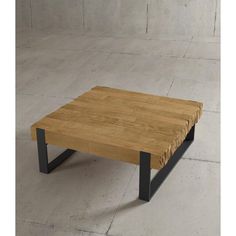 a wooden table with metal legs on concrete floor