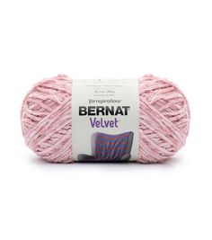 bernat velvet yarn ball in pink and purple colors on a white background with the label