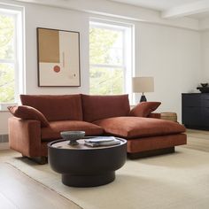 a living room filled with furniture and a large painting on the wall above the couch