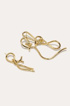 Gold vermeil twisted energetically in this elegant earrings. Secured with an earring post and butterfly back. Elegant Yellow Gold Wrap Earrings For Party, Elegant Twisted Earrings For Pierced Ears, Gold Earrings With A Modern Twist, Elegant Twisted Yellow Gold Earrings, Elegant Formal Yellow Gold Wrap Earrings, Gold Twisted Earrings, Single Gold Earring With A Modern Twist, Twisted Gold Plated Earrings For Gift, Elegant Gold Wrap Earrings For Evening