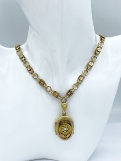 Lovely antique Victorian tri-gold filled necklace and locket. Locket features faux seed pearl set in the center of a flower and surrounded by leaves. The chain is tri-gold filled with ornate flower motif.  Measures - 17 inches long, 43.18 cm Locket measures w/o bail - 1 1/8 x 3/4 inches, 2.84 x 1.91 cm Weight - 36.09 grams.  CONDITION:  Wear to the gold plating on locket. See pictures for details. Locket opens easily and snaps shut firmly. If you like what you see here please take a moment to check out the other vintage and antique jewelry I have for sale. I combine shipping costs for multiple purchases. Gold Locket For Vintage Jewelry Collection, Victorian Gold Locket Necklace With Vintage Charm, Collectible Gold Jewelry With Detachable Pendant, Vintage Hallmarked Flower Pendant Necklace, Vintage Charm Yellow Gold Flower Pendant Necklace, Gold Heirloom Jewelry With Detachable Pendant, Heirloom Gold Jewelry With Detachable Pendant, Vintage Necklace With Flower Pendant, Gold Necklaces With Detachable Pendant For Collectors