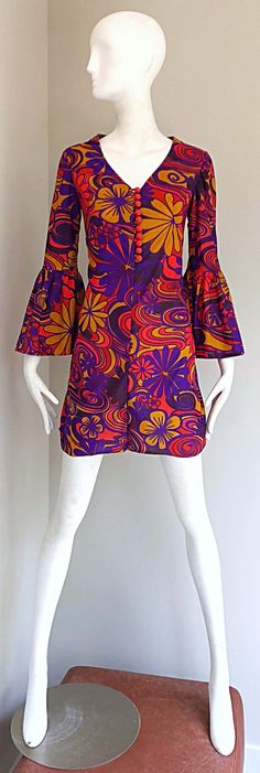 For Sale on 1stDibs - Amazing early 1970s flower power psychedelic tunic mini dress! Features flowers in various sizes, mixed with psychedelic prints. Vibrant colors of purple, Hippie Mini Dress With Floral Print, Festival Multicolor Floral Print Mini Dress, 1970s Style Mini Dress For Spring, Vintage Multicolor Floral Print Mini Dress, Retro Multicolor Mini Dress With Floral Print, Multicolor Groovy Dress With Retro Print, Groovy Multicolor Dress With Retro Print, Multicolor Retro Print Hippie Dress, Multicolor Hippie Dress With Retro Print