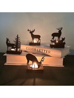 three deer bookends sitting on top of each other with the words cover letter lit up