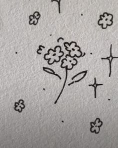 some black and white drawings on paper with flowers in the middle, cross marks above them