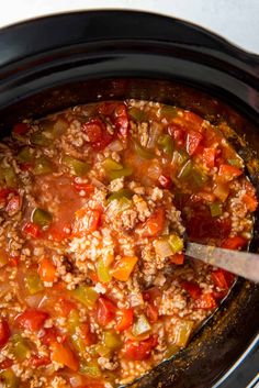 a crock pot filled with ground beef and vegetables