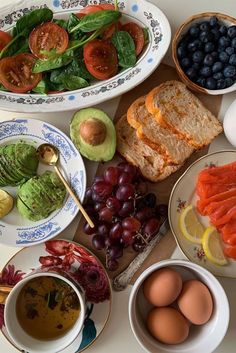 a table topped with plates and bowls filled with different types of food next to each other