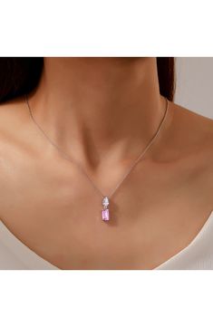 An emerald-cut pink sapphire shines beneath an equally brilliant simulated diamond on this polished necklace rendered from sterling silver bonded in platinum. 20" length; 3/4"W x 3/4"L pendant Sterling silver bonded with platinum/lab-grown sapphire/simulated diamond Imported Sapphire Pendant Necklace, Sapphire Necklace Pendants, Sapphire Pendant, Pink Sapphire, Emerald Cut, Lab Grown, Lab Grown Diamonds, Platinum, Emerald