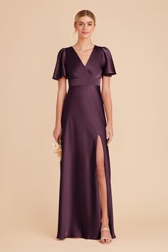 a woman in a long purple dress with a slit down the side and short sleeves