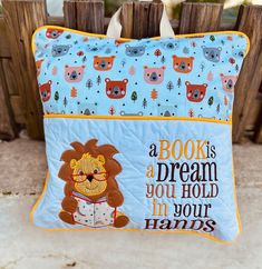 a book is a dream, you hold in your hands pillow with an image of a lion on it