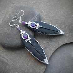 These statement black raven feathers earrings are hand-sculpted of polymer clay and decorated with amethysts gems. Elegant, lightweight and comfortable to wear, they will for sure bring attention to their owner's neckline. Can be a great gift for the raven lover or just a part of Gothic, witchy or Halloween outfit. Perfect match to the raven necklace: https://www.etsy.com/listing/1272180892 Earring length about 3 inches (from the top of the earwire) Drop length 2 1/3 inches Earring width 2/3 inc Crow Feather Earrings, Raven Inspired Outfits, Raven Earrings, Raven Feathers, Feathers Earrings, Blue Nile Jewelry, Raven Feather, Raven Jewelry, Raven Necklace