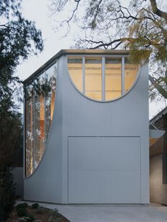 a house that has a curved window on the side