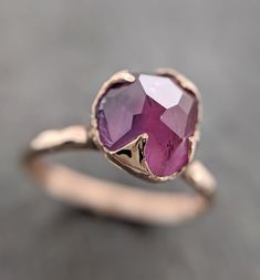 Partially faceted (by my husband) Purple Sapphire Solitaire. I hand carved this ring in wax and cast it in recycled solid 14k Yellow gold using the lost wax casting process. This one of a kind raw gemstone ring is a size 7 it can be resized. The sapphire stone measures about 9mm X 8mm. Throughout all time and history in every tribe and culture all around the world crystals, minerals and gemstones have used for healing, luck, divination, adornment vibrational medicine and so much more. Sapphire i Hand Forged Ruby Ring For Anniversary, Elegant Hand Forged Ruby Ring For Anniversary, Raw Gemstone Ring, Sapphire Solitaire, Wedding Rings Solitaire, Purple Sapphire, Purple Band, Rose Gold Engagement, Minerals And Gemstones