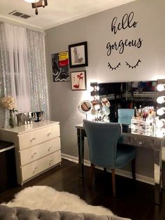 a bedroom with a vanity, mirror and lights on it's wall above the bed