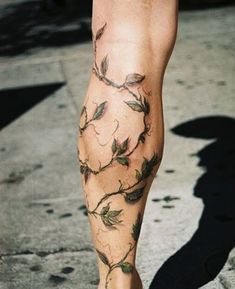 a person's legs with leaves on them