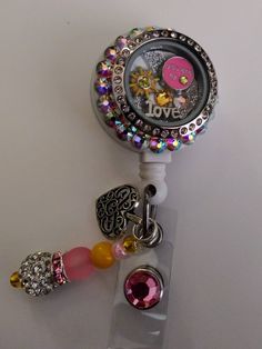 Charms can vary based on stock but will always be very similar and just as cute!!Floating locket with swarovski Crystal collection! Swarovski crystals on this badge makes it one of a kind! This is a cute You R my sunshine floating locket badge reel. Comes as shown in picture! Badge reel This cute badge reel is handmade and comes with a very cute charm and dangling beads as shown in the pic. Show off your new handmade badge reel to all your co-workers All badge reels come on a slide clip! Alligat Customizable Silver Badge Reel Gift, Customizable Silver Badge Reel As Gift, Personalized Badge Reel For Valentine's Day Gift, Personalized Silver Badge Reel For Gift, Personalized Silver Badge Reel Gift, Personalized Silver Badge Reel As Gift, Cute Badge Reel, Floating Lockets, Locket Charms