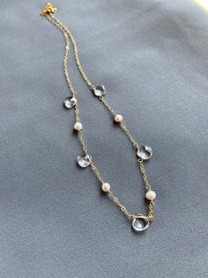 🌟🌟🌟A perfect balance in harmony - pearls and clear quartz.  This necklace lies delicately at the base of the throat.  Makes a great gift for your bridesmaids or yourself.+ Picture #2 was a collection made for a bridal party.+ Quartz. Freshwater Pearls. Gold Fill Chain & Lobster Clasp.+ Necklace measures 17 inches (43.18 cm) in length.+ Necklace takes 1 business day to ship.+ Your jewelry will come in a jewelry box, tied with our a ribbon.+ Listing is for one (1) necklace.+ Bridal discount Elegant Crystal Necklace With Pearl Drop As Gift, Elegant Pearl Drop Crystal Necklace Gift, Elegant Gold Crystal Necklace With Pearl Drop, Elegant Gold Pearl Crystal Necklace, Briolette Pearl Necklace For Weddings, Pearl White Briolette Pearl Necklace For Weddings, Pearl Necklaces With Faceted Detail As Gift, Elegant Crystal Necklaces With Pearl Drop, Elegant Pearl Crystal Necklaces For Parties