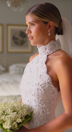 a woman in a wedding dress holding a bouquet