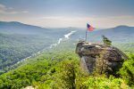 a flag on top of a rock in the mountains