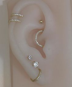 three different types of ear piercings on top of each other