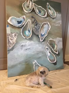 a small dog is sitting in front of an art work with oysters on it