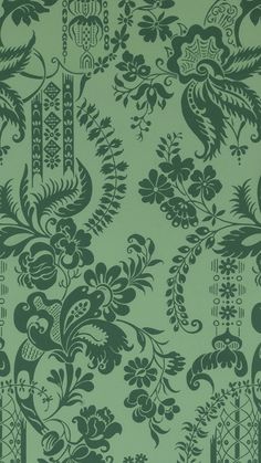 a green wallpaper with floral designs on it