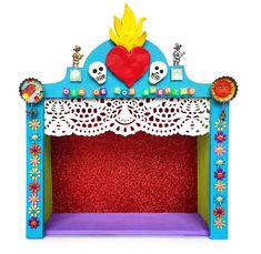 a brightly colored children's fire place with skulls and flowers on the top, red carpet below