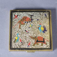 an intricately decorated box with birds and elephants