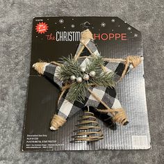 an ornament on the cover of a magazine with a christmas star hanging from it