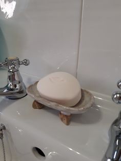 a soap dish sitting on top of a white sink