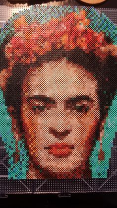 a close up of a person's face on a piece of art made out of legos