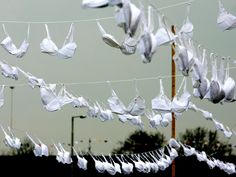 some white paper birds hanging from a line